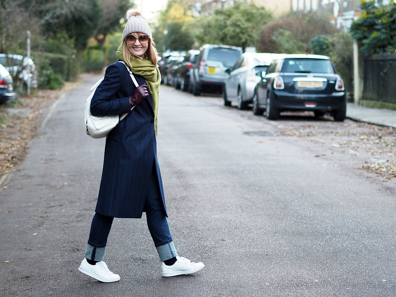 Smart cold weather layered outfit navy pinstripe wool coat moss green wool scarf bobble hat white backpack and Adidas Stan Smiths deep hem straight leg jeans | Not Dressed As Lamb, over 40 style