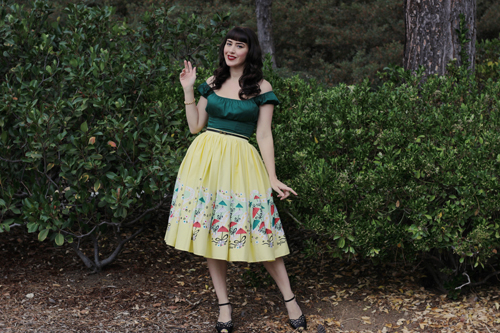Pinup Girl Clothing Pinup Couture Peasant Top in Dark Green Jenny Skirt in Mary Blair Yellow Umbrellas Print
