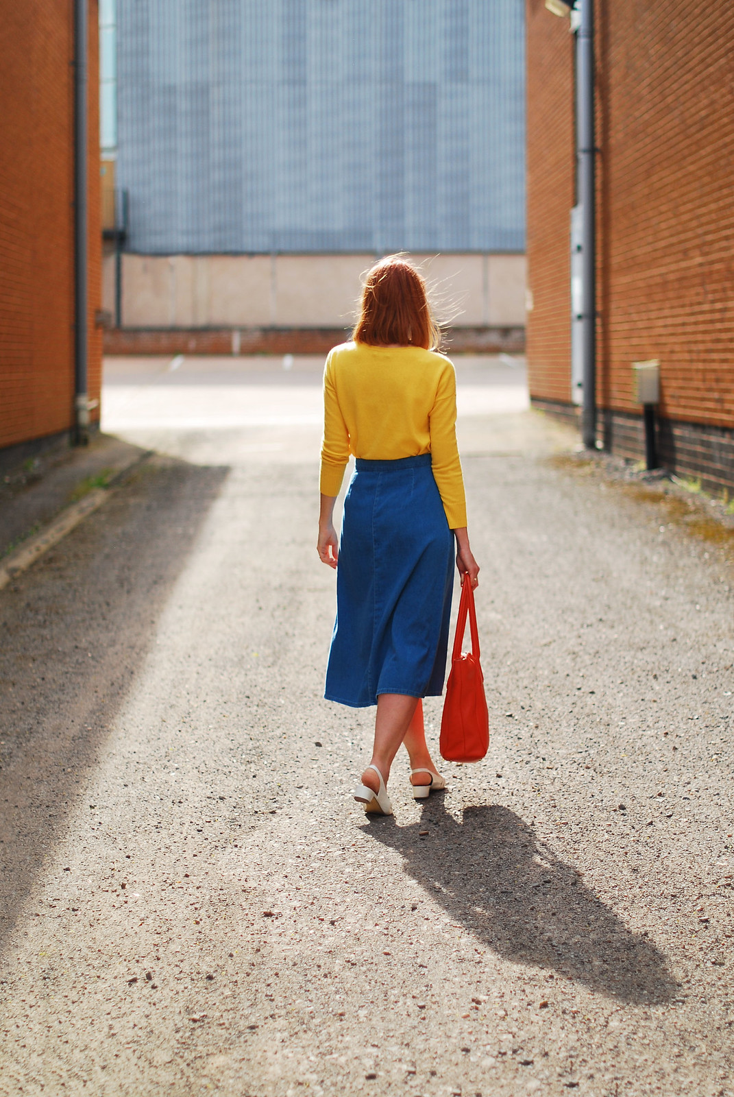 Primary brights colour blocking: Yellow sweater, denim midi skirt, orange tote bag, white pointed flats | Not Dressed As Lamb