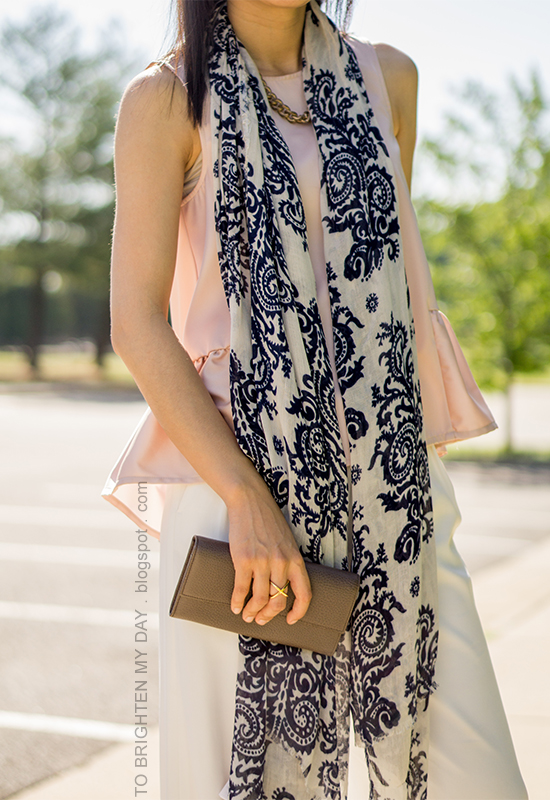 blue floral scarf, gold jewelry, pink peplum top, taupe clutch, white wide-legged trousers