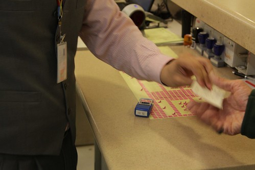 Gate staff place stickers on ferry tickets to indicate seat reservations