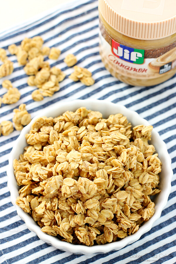 Granola in a white bowl with a jar of Jif peanut butter.