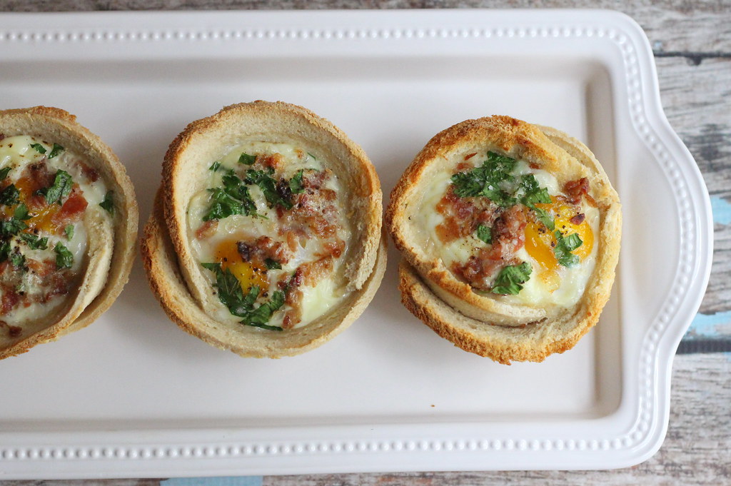 egg toast cups with parsley pepper and and bacon on tray