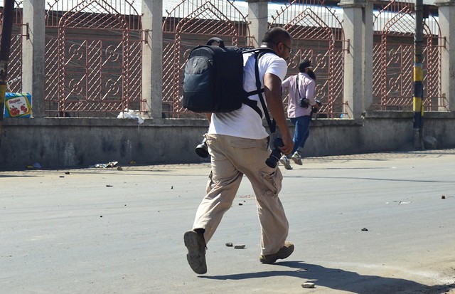 Photo Journalists running for cover from stones pelted by protestors in Srinagar (Photo by_ Raqib Hameed Naik).JPG