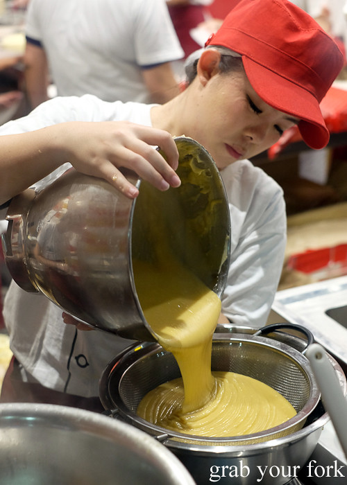Sieving the honey madeleine batter at Uncle Tetsu's Cheesecake at Regent Place Sydney